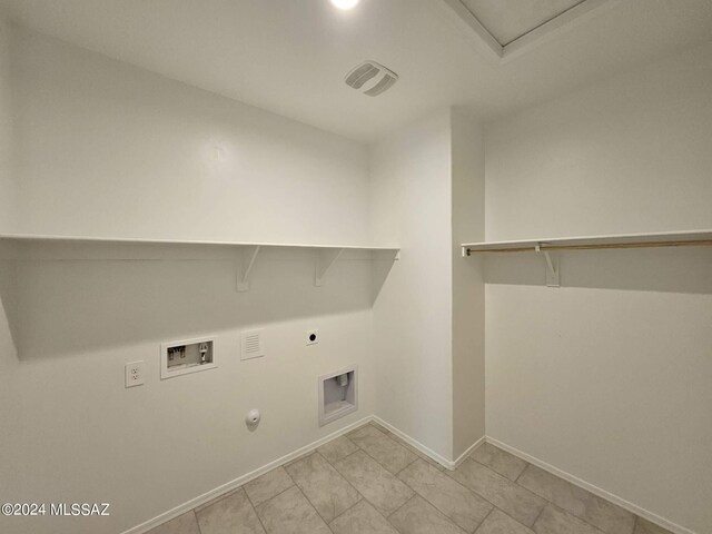 laundry area with hookup for a washing machine, hookup for an electric dryer, baseboards, gas dryer hookup, and laundry area