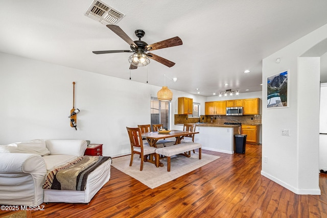 dining area with ceiling fan, visible vents, dark wood finished floors, baseboards, and recessed lighting
