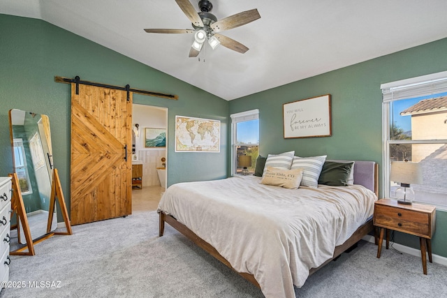 bedroom featuring carpet floors, a barn door, a ceiling fan, and vaulted ceiling