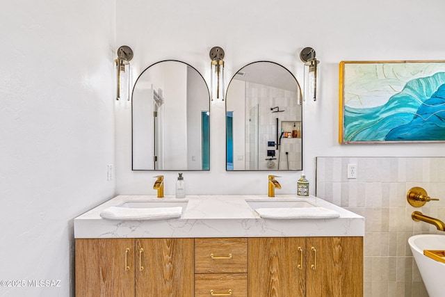 full bathroom featuring double vanity, a sink, and a soaking tub