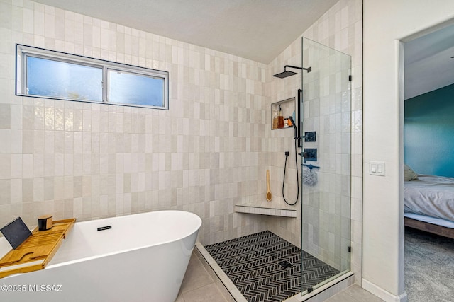 bathroom with connected bathroom, tile patterned floors, a soaking tub, and tiled shower