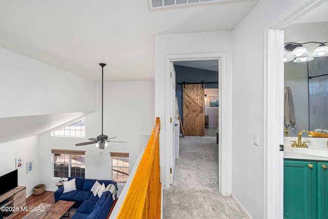hallway featuring a sink and baseboards