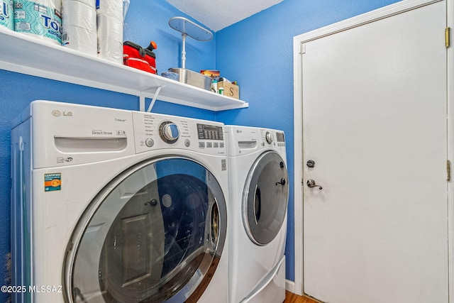 laundry room with washing machine and clothes dryer and laundry area