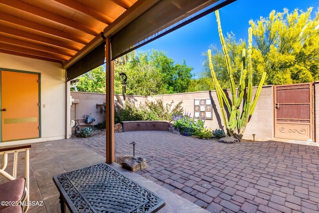 view of patio featuring a fenced backyard and a gate