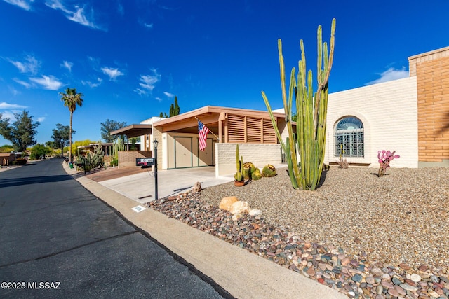view of front of house featuring an attached carport and concrete driveway