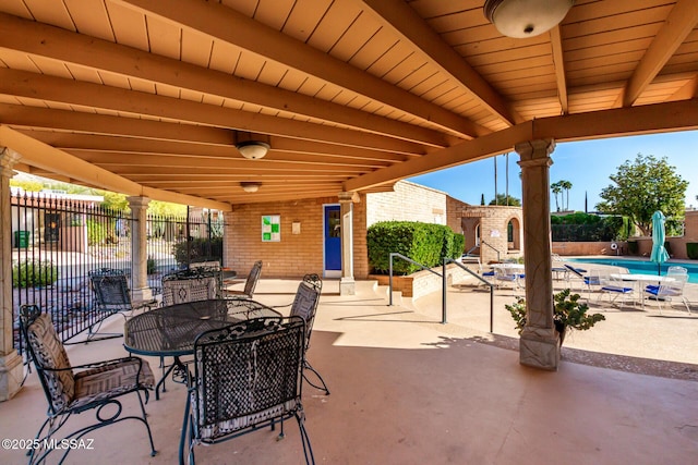 view of patio / terrace with a fenced in pool, fence, and outdoor dining space