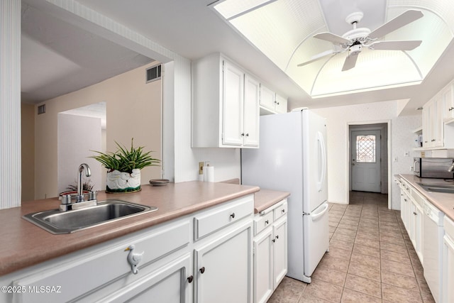 kitchen with visible vents, a sink, and white cabinets