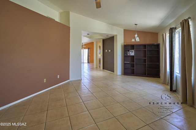 4703 W Gatehinge Ct, Tucson, AZ 85741 - empty room with lofted ceiling, light tile patterned flooring, and a chandelier