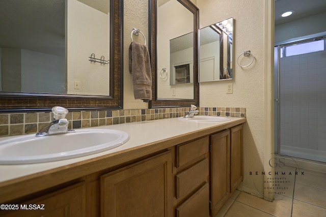 4703 W Gatehinge Ct, Tucson, AZ 85741 - bathroom featuring tile patterned flooring, double vanity, a textured wall, and a shower with shower door