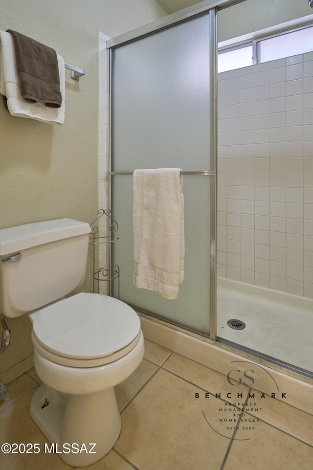 4703 W Gatehinge Ct, Tucson, AZ 85741 - bathroom with a stall shower, toilet, and tile patterned flooring