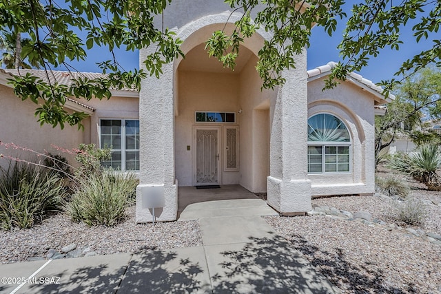 doorway to property with stucco siding