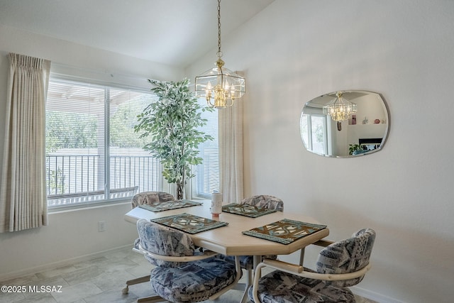 dining area with an inviting chandelier, baseboards, plenty of natural light, and vaulted ceiling