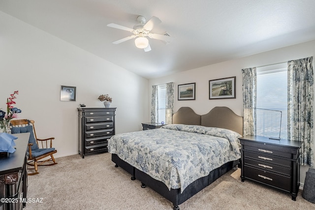 bedroom featuring ceiling fan, vaulted ceiling, and light carpet