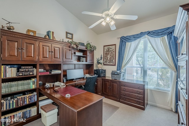 office space featuring a ceiling fan, vaulted ceiling, light carpet, and a healthy amount of sunlight
