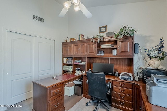 home office featuring a ceiling fan, visible vents, and built in study area