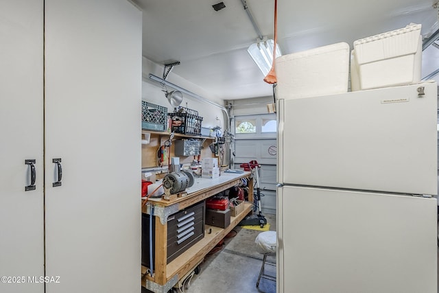 kitchen with freestanding refrigerator and concrete floors