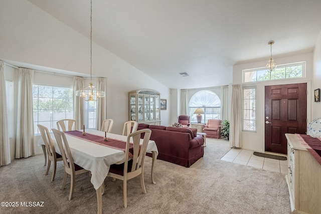 dining space with plenty of natural light, a chandelier, and light colored carpet