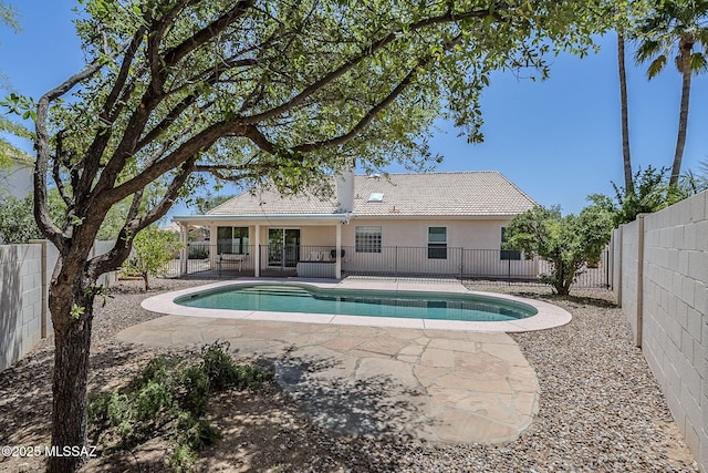 view of pool featuring a patio, a fenced in pool, and a fenced backyard