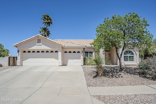 ranch-style house with an attached garage, stucco siding, driveway, and a tiled roof