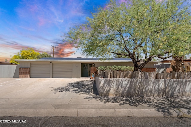 3202 W Calle Cereza, Tucson, AZ 85741 - view of front of property featuring driveway, an attached garage, fence, and brick siding