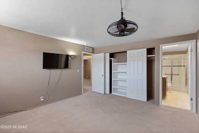 3202 W Calle Cereza, Tucson, AZ 85741 - unfurnished bedroom with a closet, visible vents, light carpet, and ensuite bathroom