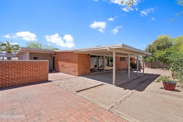 3202 W Calle Cereza, Tucson, AZ 85741 - view of front of house featuring brick siding, a carport, a patio area, and fence