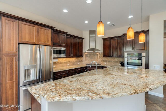 36330 S Desert Sun Dr, Tucson, AZ 85739 - kitchen featuring stainless steel appliances, wall chimney range hood, backsplash, a spacious island, and light stone countertops