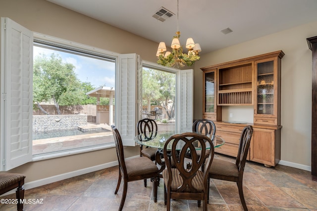 36330 S Desert Sun Dr, Tucson, AZ 85739 - dining area with a chandelier, baseboards, and stone tile floors