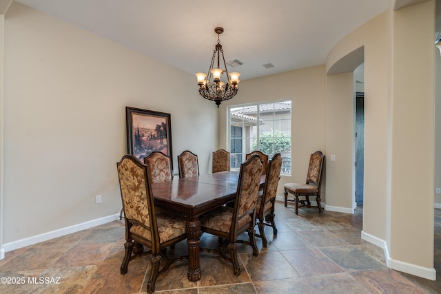 36330 S Desert Sun Dr, Tucson, AZ 85739 - dining area featuring a chandelier, stone finish flooring, and baseboards