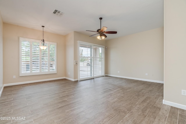 36330 S Desert Sun Dr, Tucson, AZ 85739 - empty room with a ceiling fan, wood finished floors, and baseboards