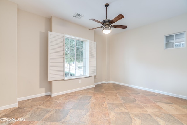 36330 S Desert Sun Dr, Tucson, AZ 85739 - unfurnished room featuring stone finish flooring, ceiling fan, and baseboards