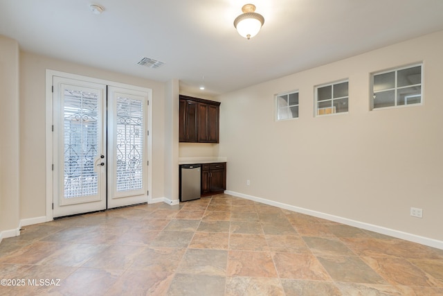 36330 S Desert Sun Dr, Tucson, AZ 85739 - unfurnished living room featuring healthy amount of natural light, stone finish flooring, and baseboards