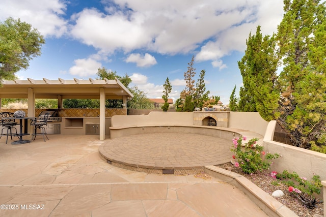 36330 S Desert Sun Dr, Tucson, AZ 85739 - view of patio with exterior kitchen, an outdoor stone fireplace, and fence