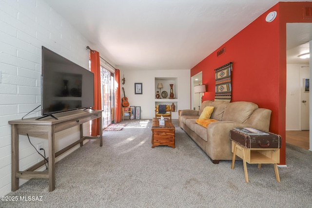 carpeted living room with visible vents and built in features