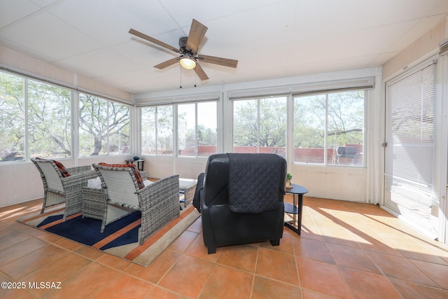 sunroom featuring a healthy amount of sunlight and a ceiling fan