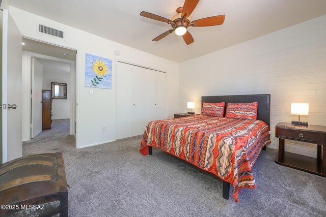 bedroom featuring visible vents, carpet flooring, ceiling fan, and a closet