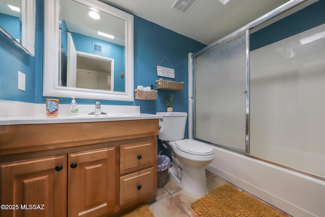 full bathroom with toilet, tile patterned floors, visible vents, and vanity