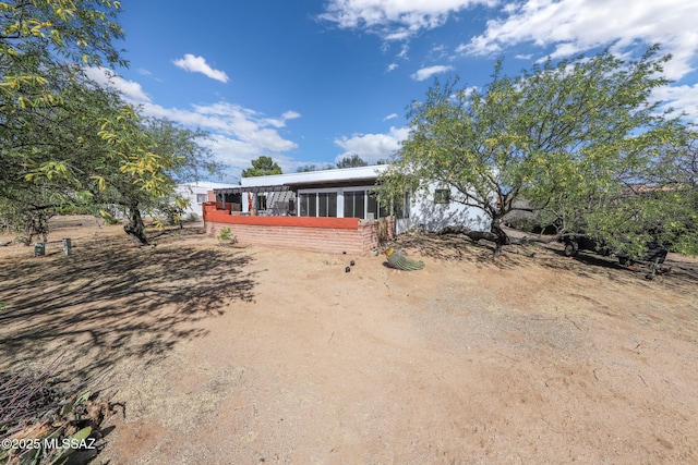view of front of house featuring a sunroom