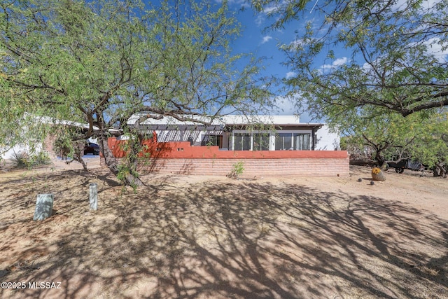 rear view of house featuring a sunroom