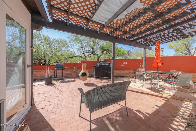 view of patio featuring a fenced backyard, a pergola, and outdoor dining space