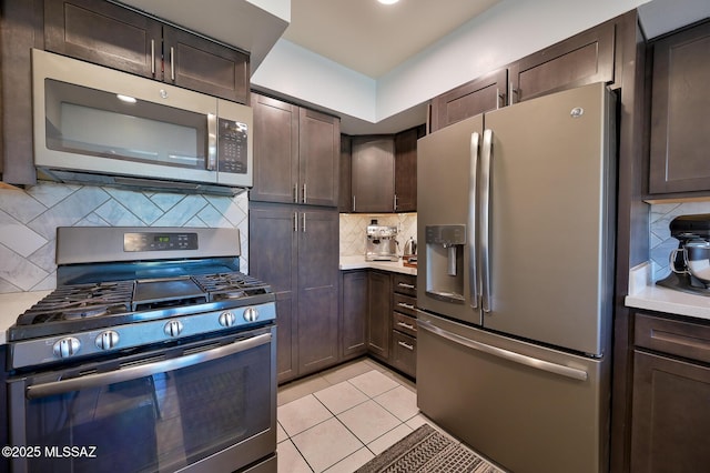 kitchen with backsplash, dark brown cabinetry, appliances with stainless steel finishes, and light countertops