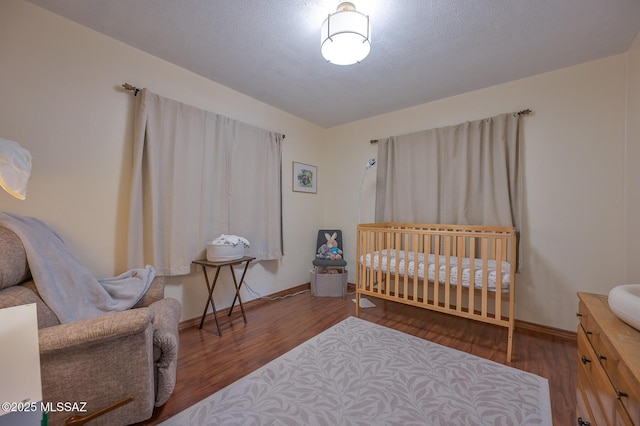 bedroom featuring baseboards and wood finished floors