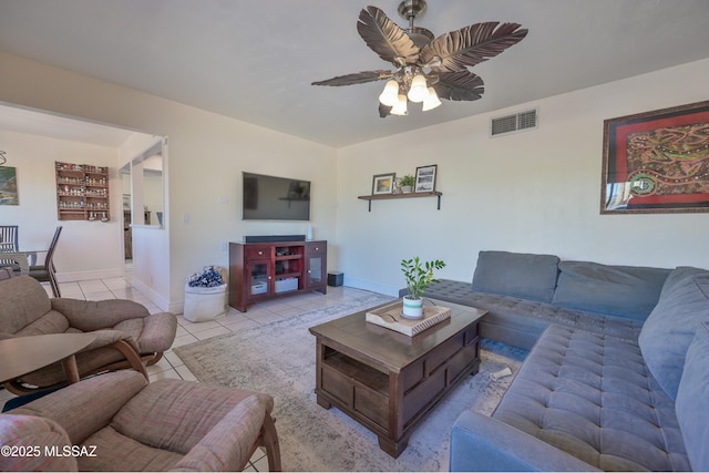 living room with baseboards, a ceiling fan, visible vents, and light tile patterned floors