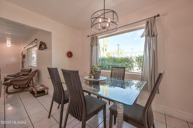 dining space featuring baseboards, a notable chandelier, and light tile patterned floors