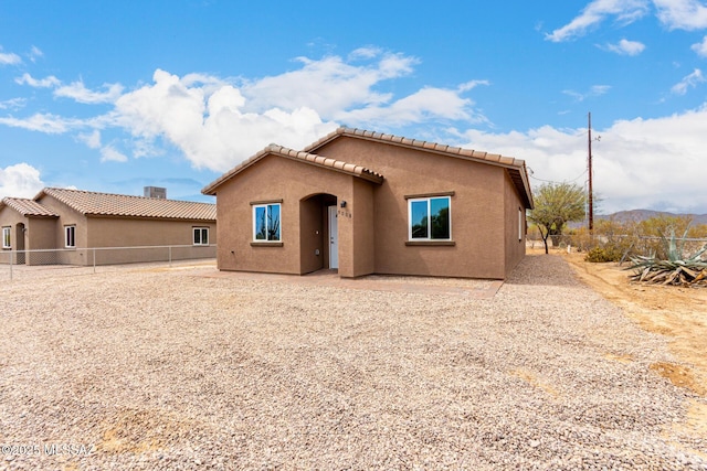 9008 W Bruce St, Tucson, AZ 85735 - back of house with a tile roof, a fenced backyard, and stucco siding