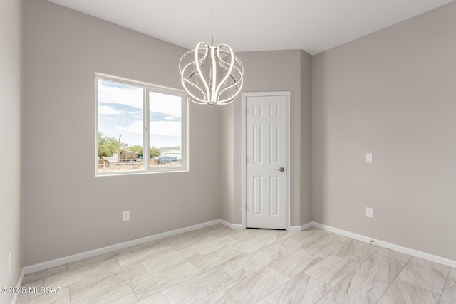 9008 W Bruce St, Tucson, AZ 85735 - spare room featuring baseboards and a notable chandelier
