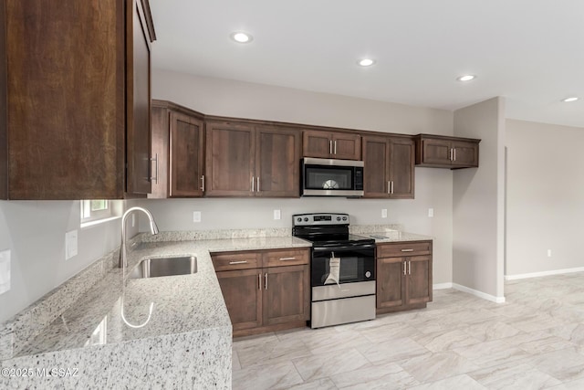 9008 W Bruce St, Tucson, AZ 85735 - kitchen with stainless steel appliances, a sink, recessed lighting, and light stone counters
