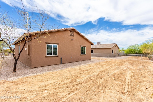9008 W Bruce St, Tucson, AZ 85735 - view of side of home featuring stucco siding and fence