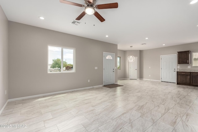 9008 W Bruce St, Tucson, AZ 85735 - unfurnished living room with recessed lighting, visible vents, a wealth of natural light, and ceiling fan