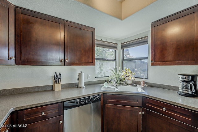 kitchen with dark brown cabinets, a sink, and dishwasher